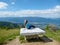 Millstaettersee - A woman in a blue T-shirt sitting on a stony table and enjoying the panoramic view on the vast valley
