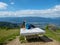 Millstaettersee - A woman in a blue T-shirt sitting on a stony table and enjoying the panoramic view on the vast valley