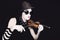 Mime playing on small violin in sunglasses