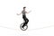 Mime riding a unicycle on a rope