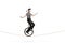 Mime riding a unicycle on a rope and holding a rose in his mouth