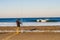 Mimizan Plage, France - April 06, 2020.  Fisherman on the shore of the Atlantic Ocean in the morning