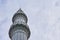 Minaret against a cloudy sky.