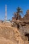 Minaret behind ruined old houses in Mut town in Dakhla oasis, Egy