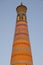 Minaret Islam Khoja in Khiva, Uzbekistan. Old minaret on the sky background in sunset.