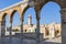 The minaret of a mosque in Old Jerusalem seen through an arch on the Haram es Sharif also known as the Temple Mount, Israel