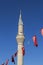 Minaret of mosque with Turkish flags