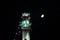 Minaret of old mosque with moon in ramadan