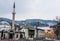 A minaret rises over buildings across the river from the Old Town neighborhood of Sarajevo,