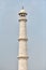 Minaret of Taj Mahal white marble mausoleum landmark in Agra, Uttar Pradesh, India, white tower