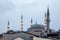 Minarets and domes of two old ottoman style mosques, Fatih and Ismet Efendi Tekke Camii, taken at dusk
