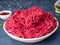 Mince beef, ground meat with ingredients for cooking on dark blu