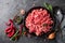 Mince. Ground meat with ingredients for cooking on black background