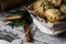 Mince pies in a basket on a table with vintage linen cloth with newspaper print, cinnamon sticks and fir tree branches,Christmas