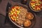 Minced beef cutlets served buckwheat porridge and stewed vegetables.