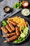 minced beef skewers with potato fries on plate