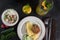 Minced meat cutlets with mashed potatoes on white plate over black wooden background. salad with radish and cucumber. Lemonade