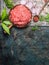 Minced meat in frying pan with wooden cooking spoon and fresh flavoring on rustic background, top view