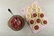 Minced meat, spoon in bowl, rings of squash with forcemeat on cutting board on wooden table. Top view