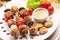 Minced meatballs baked as skewers with dip and mushrooms on whit