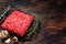 Mincemeat, Forcemeat. Raw minced beef meat on a kitchen table with herbs. Wooden background. Top view. Copy Space