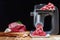 Mincer electric with fresh minced meat. Black background. Horizontal view photo.