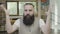 Mind blown reaction of a young attractive business man with beard sitting in the office -