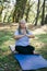 Mindful senior woman with dreadlocks meditating on nature - wellness and yoga practice