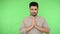 Mindful yoga, mental health. Peaceful brunette man clasping hands in prayer gesture. studio shot, chroma key