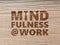 Mindfulness At Work concept using wood grain background