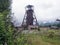 Mine head frame, Carpathian Mountains in the background, ruins, Jiu Valley, Romania