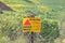 Minefield danger mines yellow warning sign on a barbed wire fence in the Golan Heights, Israel