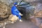 Miner man underground in a mine tunnel. Worker in overalls, safety helmet