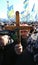 The miner at the rallies holds a crucifix in front of his face.