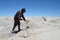 A miner shovels salt from the Salar de Uyuni, the world`s biggest salt flats. Uyuni, Bolivia