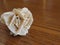 Mineral desert rose on wooden table . Also known as sand rose or rose rock or selenite rose or gypsum rose or baryte rose