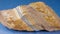 Mineral tiger eye on a blue background. Decorative and ornamental stone.