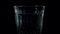Mineral water in a glass, a drink with bubbles in a glass on a black background.