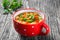 Minestrone vegetable soup with beans, cauliflower, tomatoes, close-up, top view