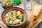 Minestrone vegetable soup with beans, cauliflower, tomatoes, close-up, top view