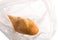 Mini baguette long loaf pastries in a transparent bag on a white background