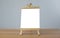 A mini blank whiteboard on  wooden table