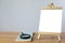 A mini blank whiteboard on  wooden table