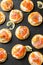 Mini blini pancakes with soft cheese, cold smoked salmon and dill