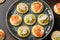 Mini blini pancakes with soft cheese, cold smoked salmon and guacamole