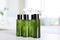 Mini bottles with cosmetic products on table in bathroom
