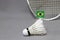 Mini Brazil flag stick on the white shuttlecock on the grey background and out focus badminton racket