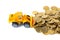 Mini bulldozer truck loading stack coin with pile of gold coin,