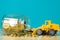 Mini bulldozer truck loading stack coin with pile of gold coin t