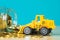 Mini bulldozer truck loading stack coin with pile of gold coin t